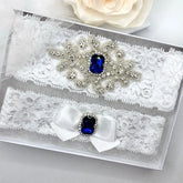 //www.adorabysimona.com/cdn/shop/files/Blue_Crystal_Bridal_Garter_Set3.webp?v=1761679522&width=165